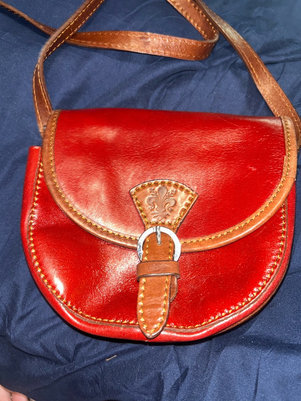 Red Leather Crossbody Bag with Brown Trim and Buckle Accent